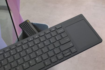 Framework's Wireless Touchpad Keyboard with a keyboard in the bin behind it.