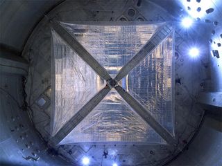 NASA engineers are testing solar sails, a unique propulsion technology which rely on sunlight to propel vehicles through space. The sail captures solar particles, called photons. This image is of a four-quadrant solar sail system, measuring 66 feet on eac