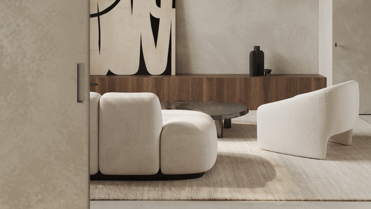 A neutral toned living room with a sliding door, cream sofa, and beige rug 