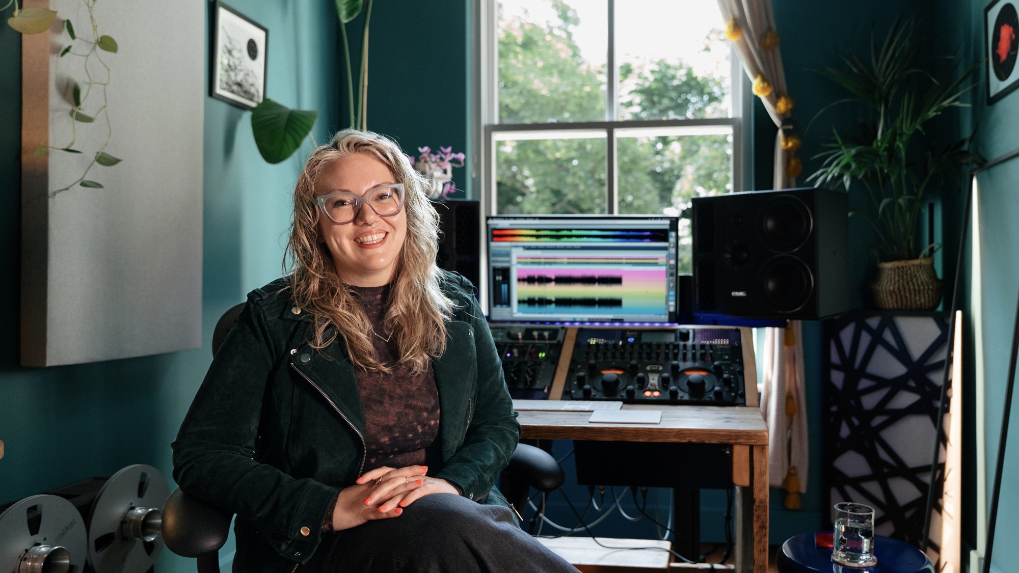 Katie Tavini press shot in front of pro tools rig