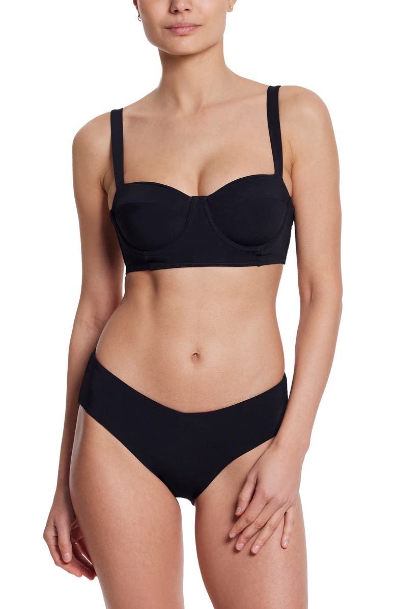 a model wears a black balconette bikini top with matching bottoms