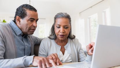 Senior couple compares paperwork to online records
