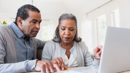 Senior couple compares paperwork to online records 