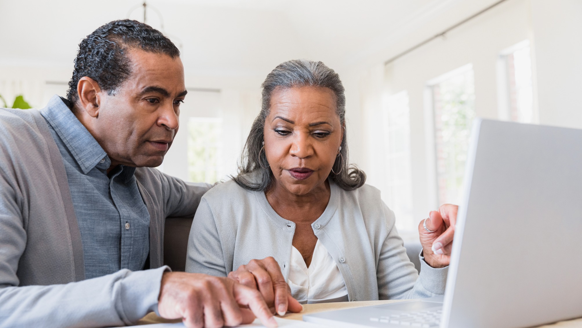 Senior couple compares paperwork to online records 