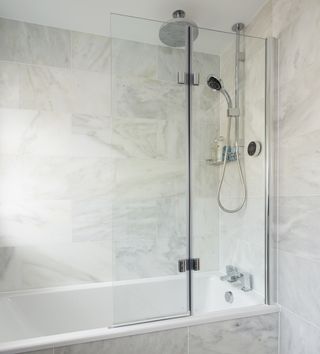 bathroom with tiles wall and bathtub