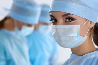 a woman surgeon with mask on