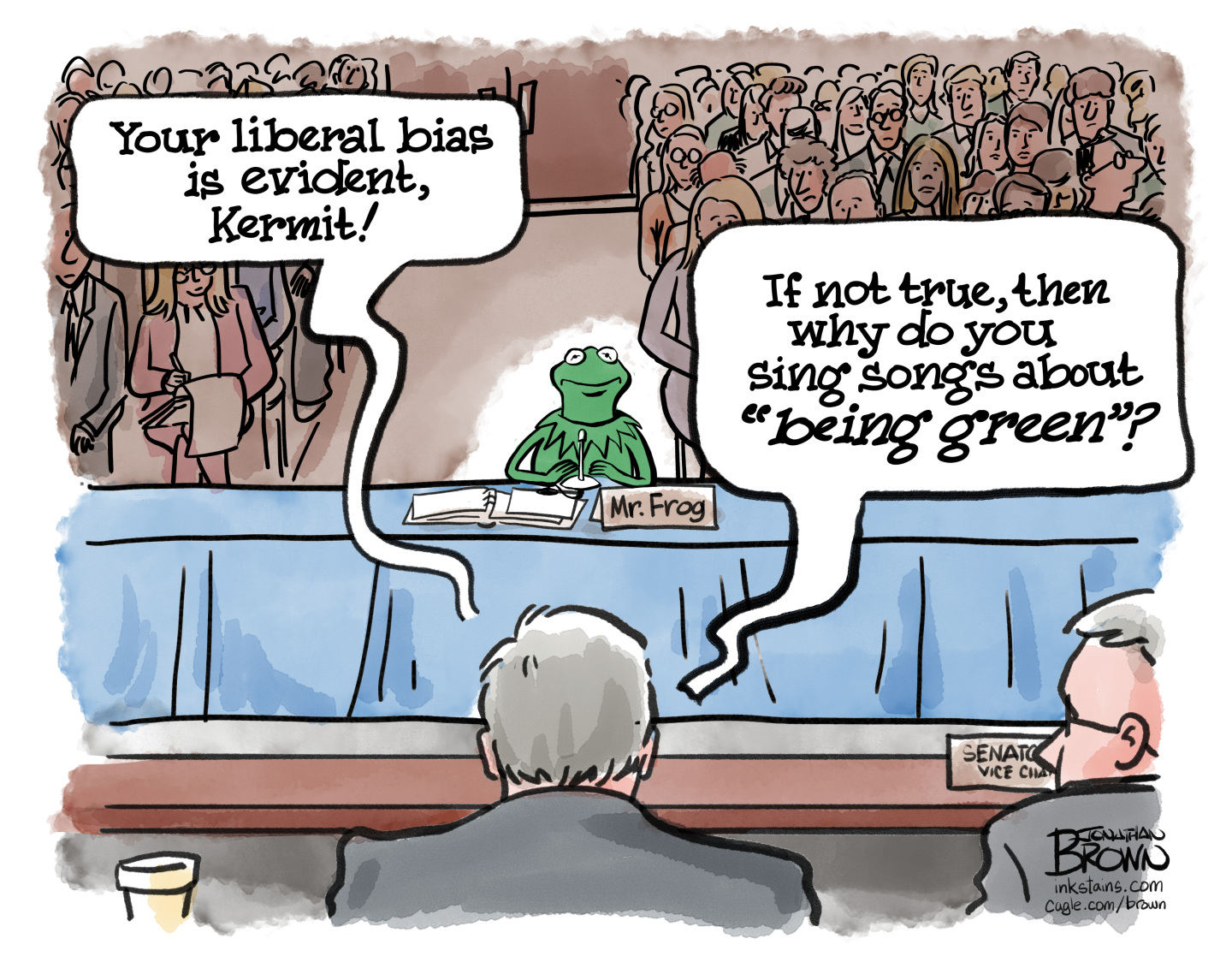 This editorial cartoon takes place in a Senate hearing room where Kermit the Frog is testifying. Kermit is behind a microphone and has a nameplate that reads “Mr. Frog.” A senator says, “Your liberal bias is evident, Kermit! If not true, then why do you sing songs about ‘being green’?”