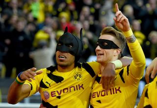 Pierre-Emerick Aubameyang and Marco Reus celebrate with Batman and Robin masks after a goal for Borussia Dortmund against Schalke in 2015.