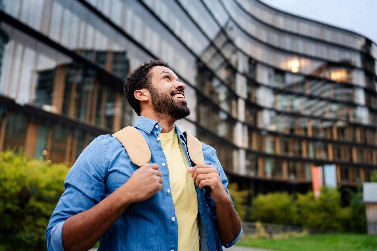 An adult student celebrates his first job in the city.