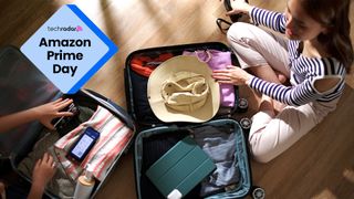 A woman sits behind an open suitcase packing for a holiday with the words 'Amazon Prime Day' next to her