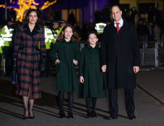 Sophie Winkleman wearing a red plaid coat walking next to her daughters Maude and Isabella in green coats and Lord Freddy Windsor in a dark coat