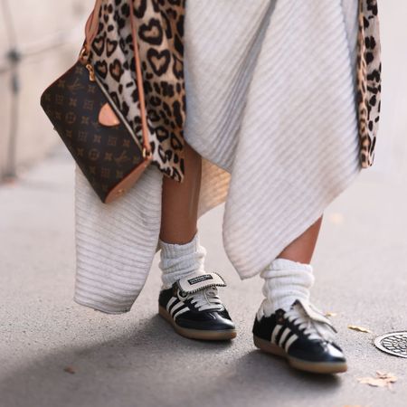 A woman walking in adidas trainers