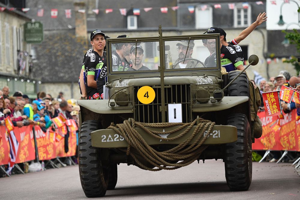Riders of the France's Fortuneo - Vital Concept cycling team take part in a parade aboard an World War II US army vehicle during the team presentation ceremony