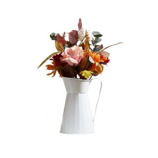 faux fall flowers in a white rustic vase