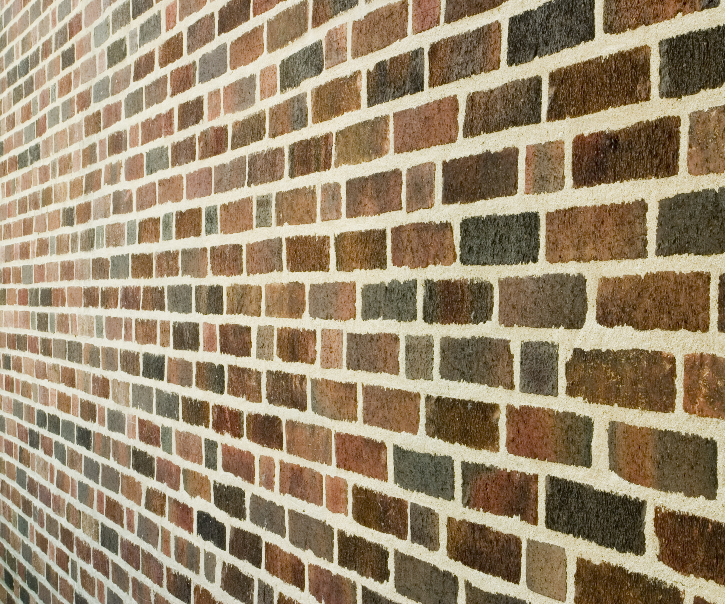A brick wall with flush pointing where the mortar comes level with the faces of the bricks