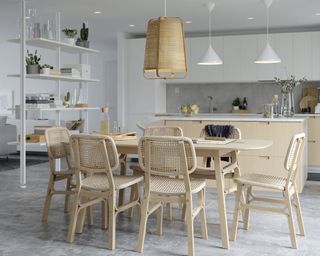 White and rattan dining room area with open storage by IKEA