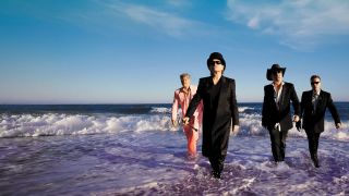 U2 walking out of the surf