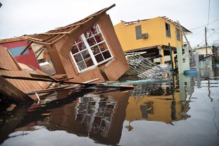 Floodwaters envelop a destroyed house in Catano town, in Juana Matos, Puerto Rico, on Sept. 21, 2017.