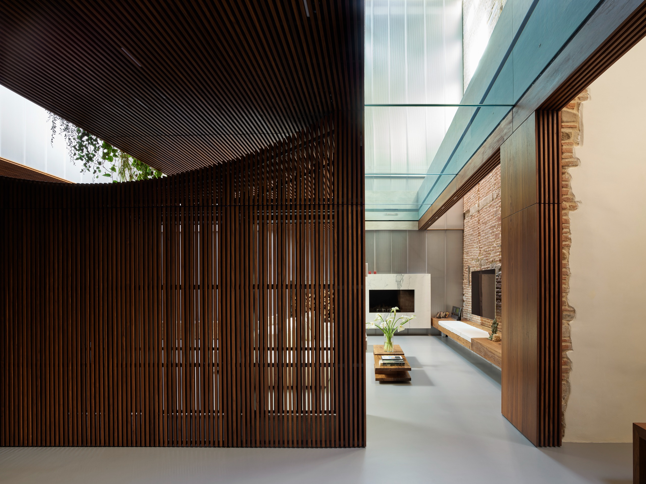 The living space is set beneath the glass-bottomed pool