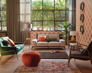 An orange, grey and brown living room with geometric wallpaper wall decor
