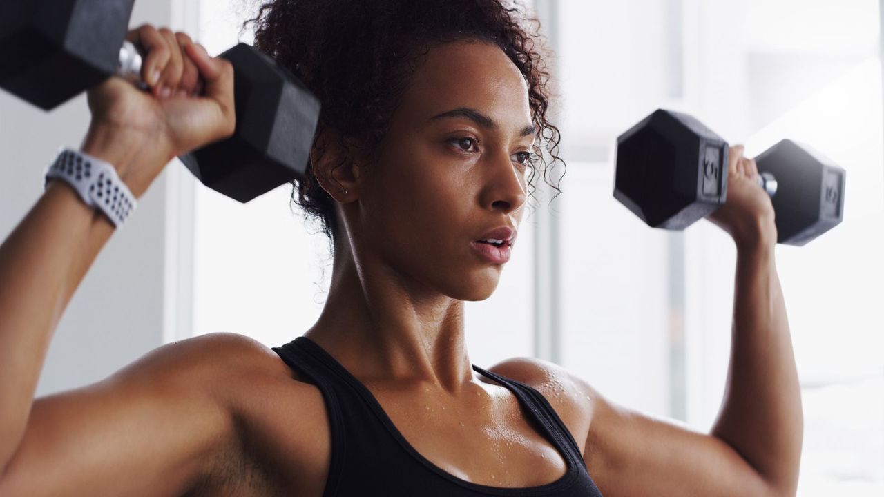 A woman performing a shoulder press