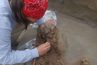 An archaeologist excavates one of the sacrificed children.