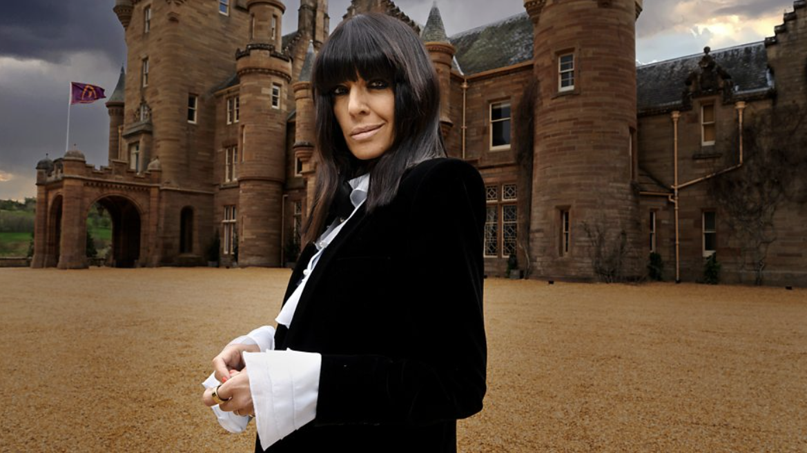 The Traitors UK season 3 host Claudia Winkleman standing in front of Ardross Castle