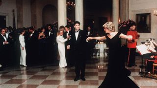washington, dc november 09 diana, princess of wales, wearing a midnight blue velvet, off the shoulder evening gown designed by victor edelstein, is watched by us president ronald reagan and first lady nancy reagan, as she dances with john travolta at the white house on november 9, 1985 in washington, dc photo by anwar hussein wireimage