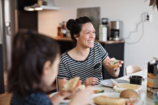 Woman eating bagel, wondering why can't I lose weight