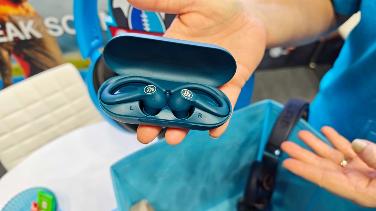 JLab's new earbuds at IFA, on a blue table