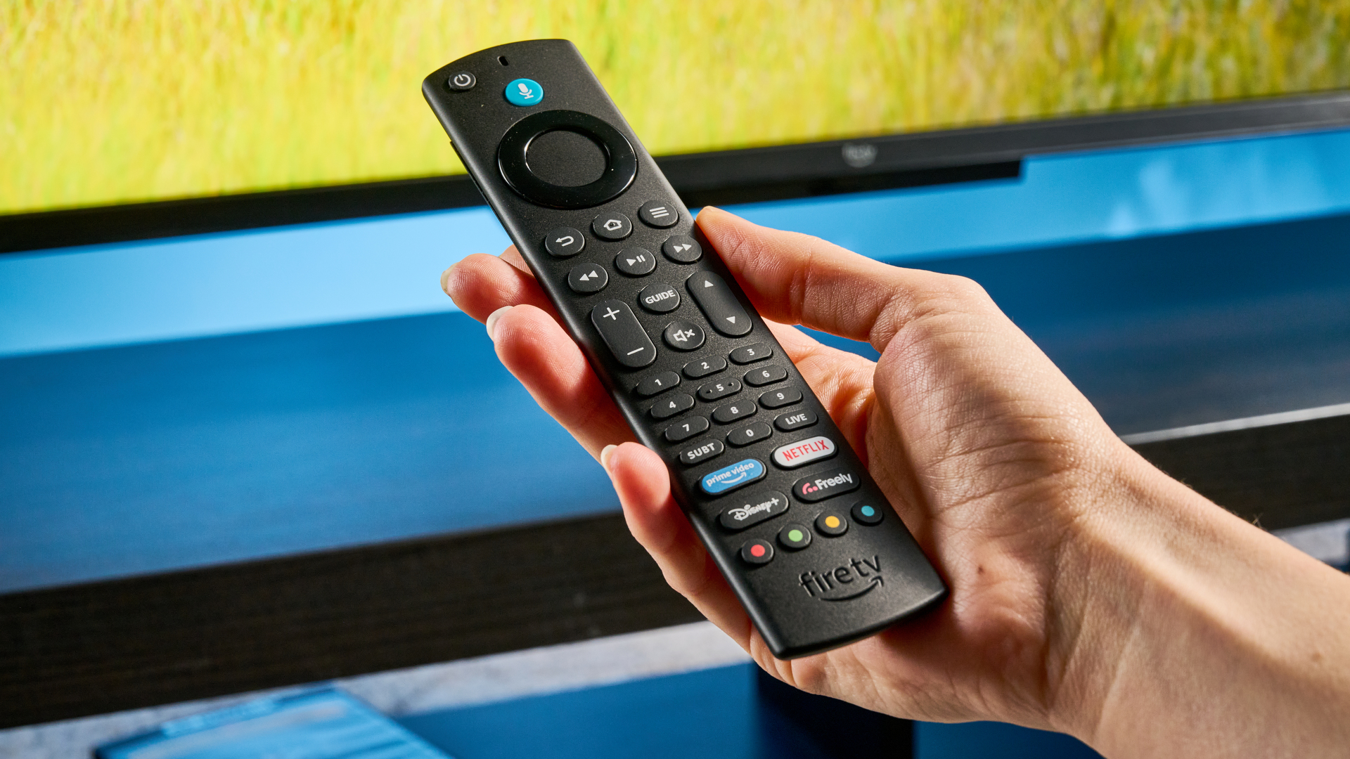 the amazon ember 4-series TV photographed against the blue tom's guide background