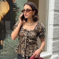 Influencer wears a leopard print top.