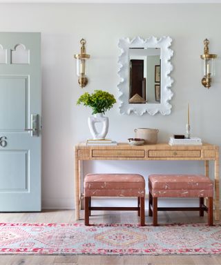 pastel pink and blue entryway with console mirror statement mirror and runner rug