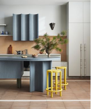 modern kitchen with blue curved island and orange tiles