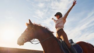 Young woman enjoying horse riding