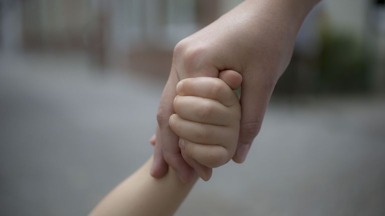 Mom and baby holding hands