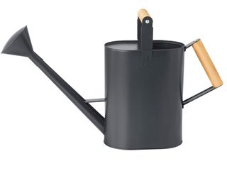 A dark grey watering can with natural wood handles on the top and side