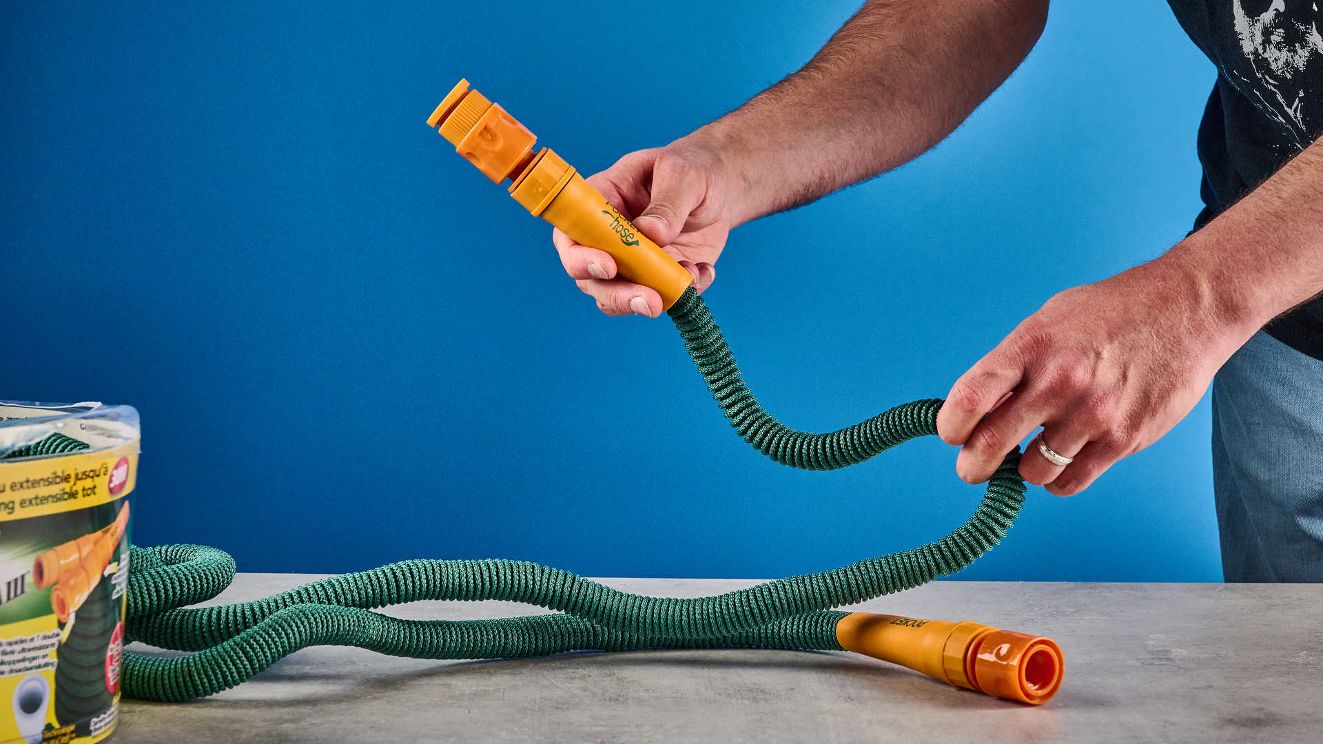 The Pocket Hose being used against a blue background