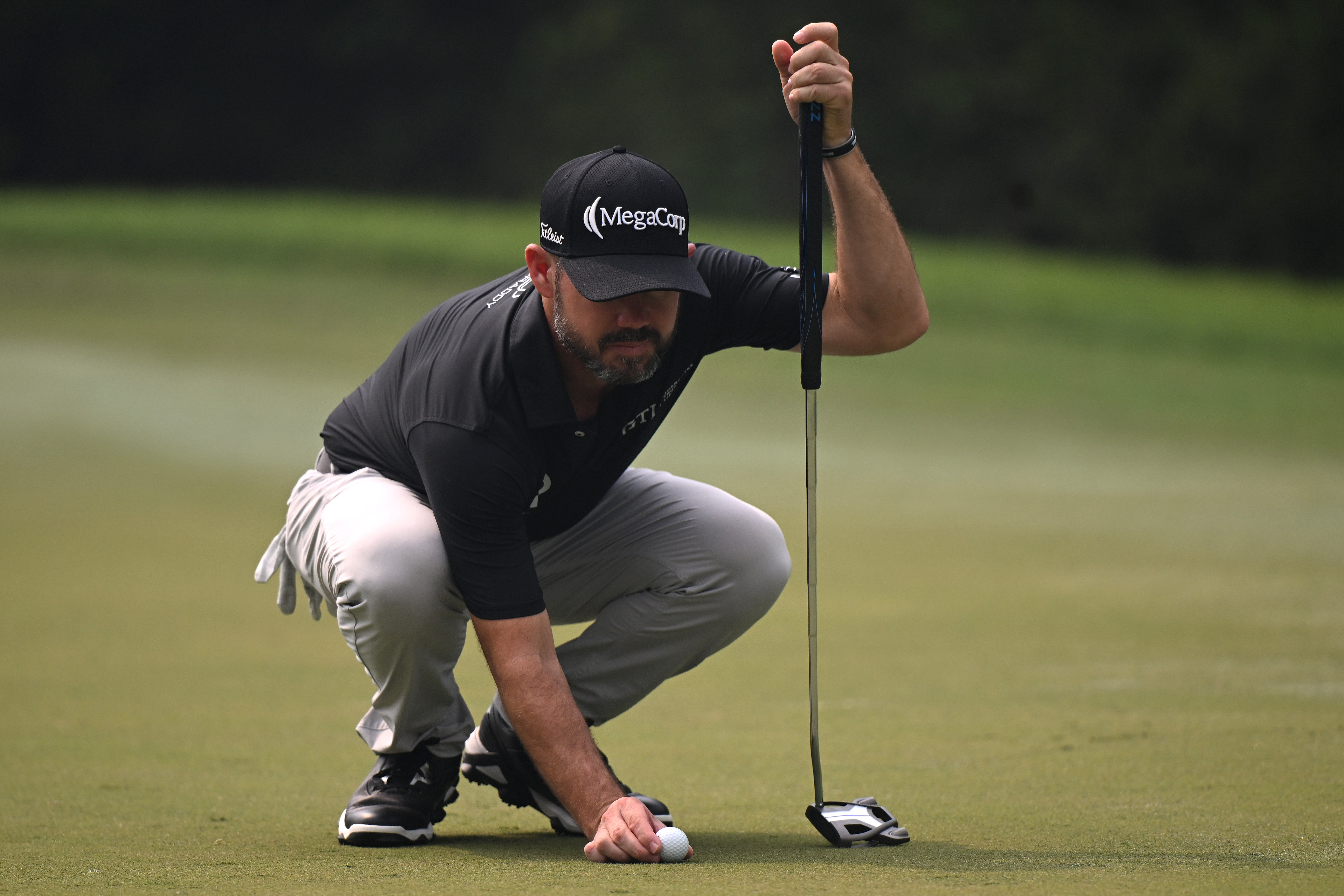 Brian Harman places his ball down on the green during the 2025 DP World India Championship
