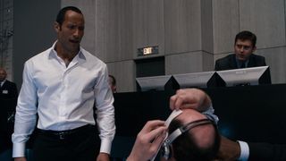 Dwayne Johnson staples a paper to a coworker's forehead in Get Smart