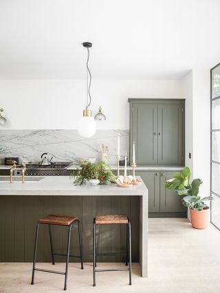 minimalist kitchen with marble island dressed for christmas with candles