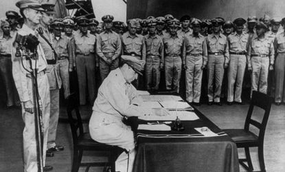 General MacArthur signs the Japanese surrender document in 1945, on board the USS Missouri in Tokyo Harbor. 
