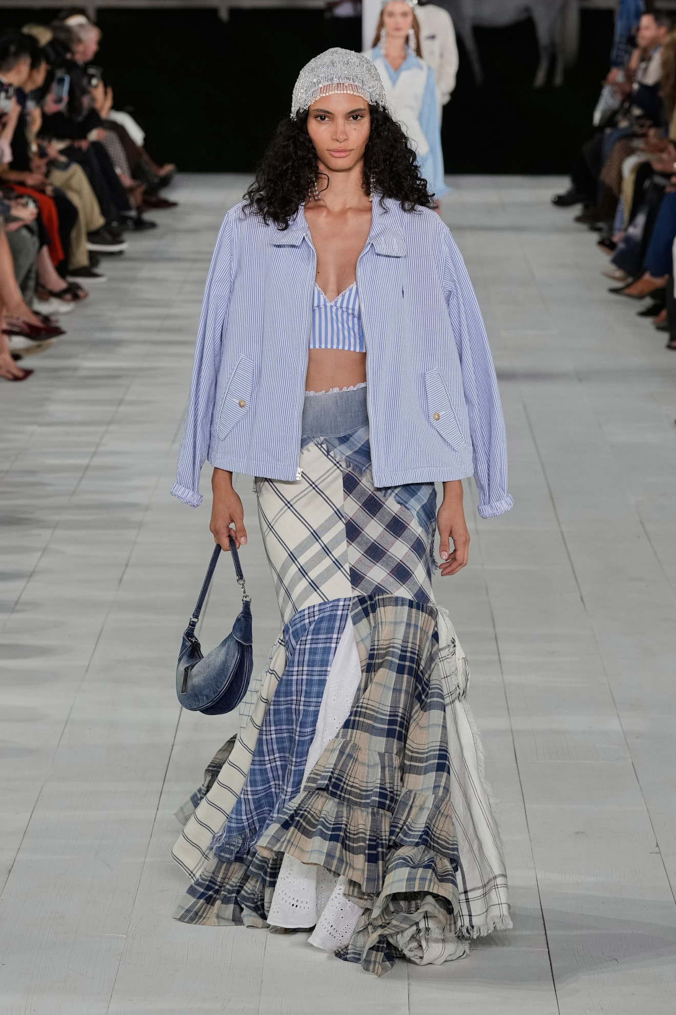 woman wearing a blazer, plaid skirt, and bralette on the ralph lauren spring 2025 runway