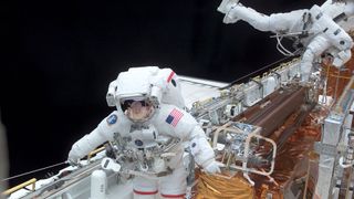 Astronauts John M. Grunsfeld and Richard M. Linnehan on a spacewalk.