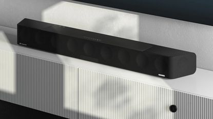 a tv in a modern living room with a soundbar underneath