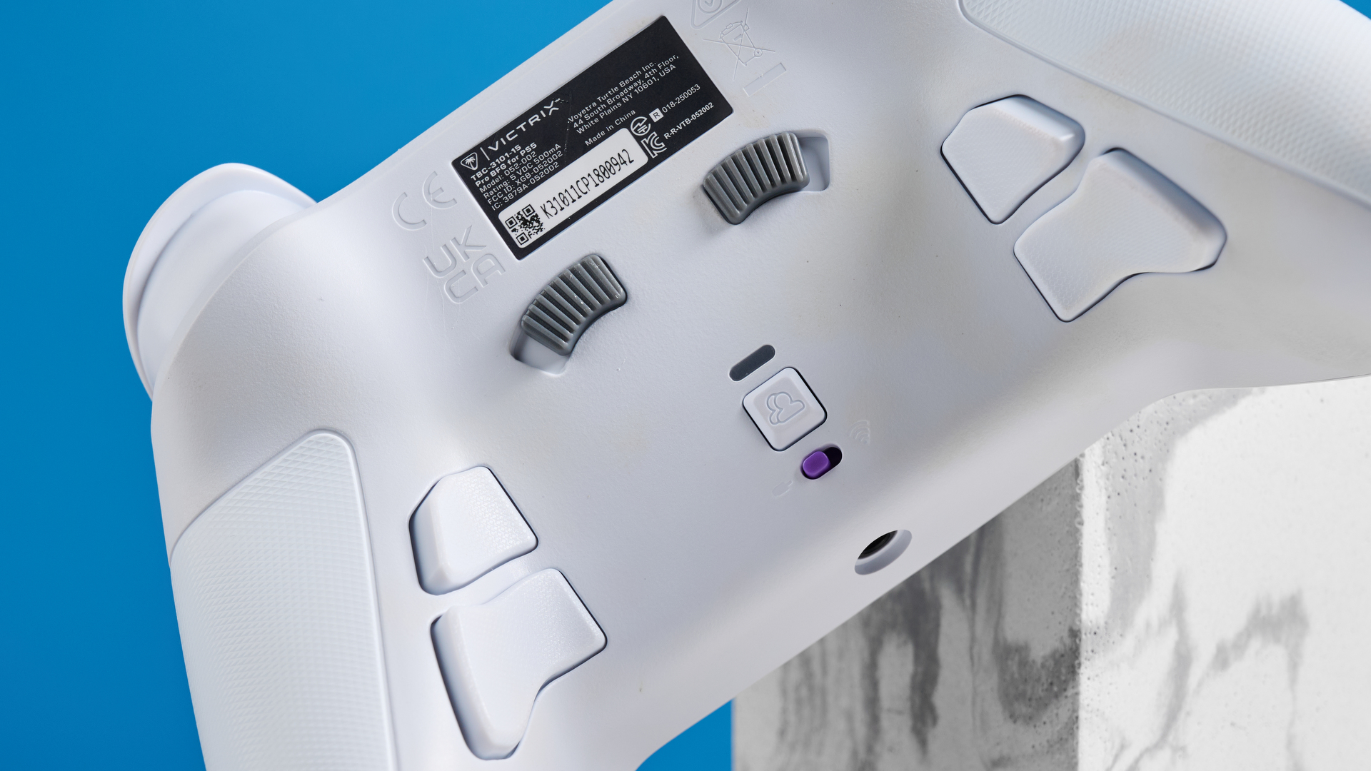 A white Turtle Beach Victrix Pro BFG Reloaded controller for the PS5