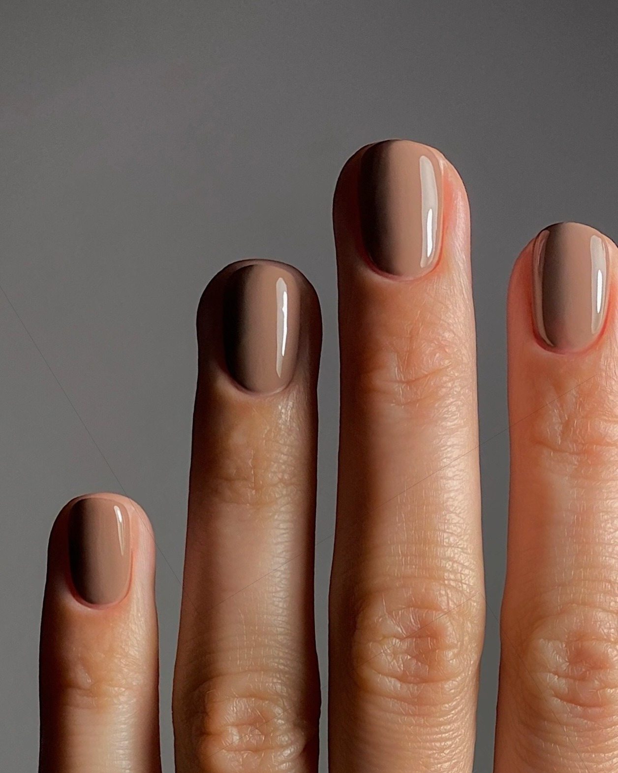 A close-up of a cappuccino-inspired manicure