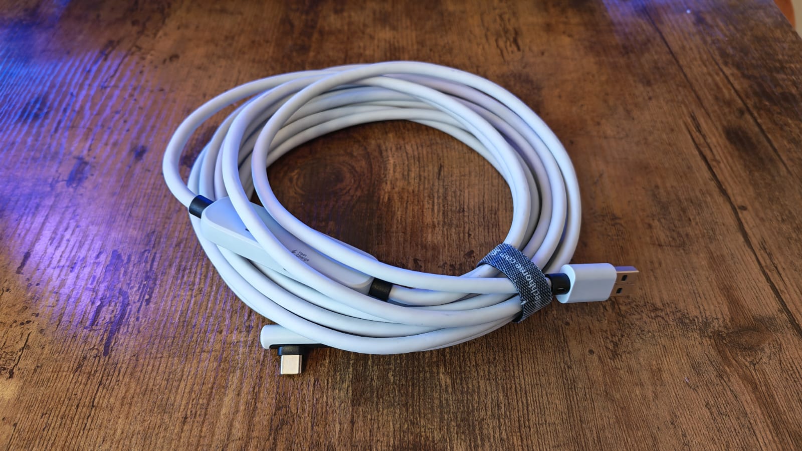 A reel of the Syntech Link Cable on a wooden desktop