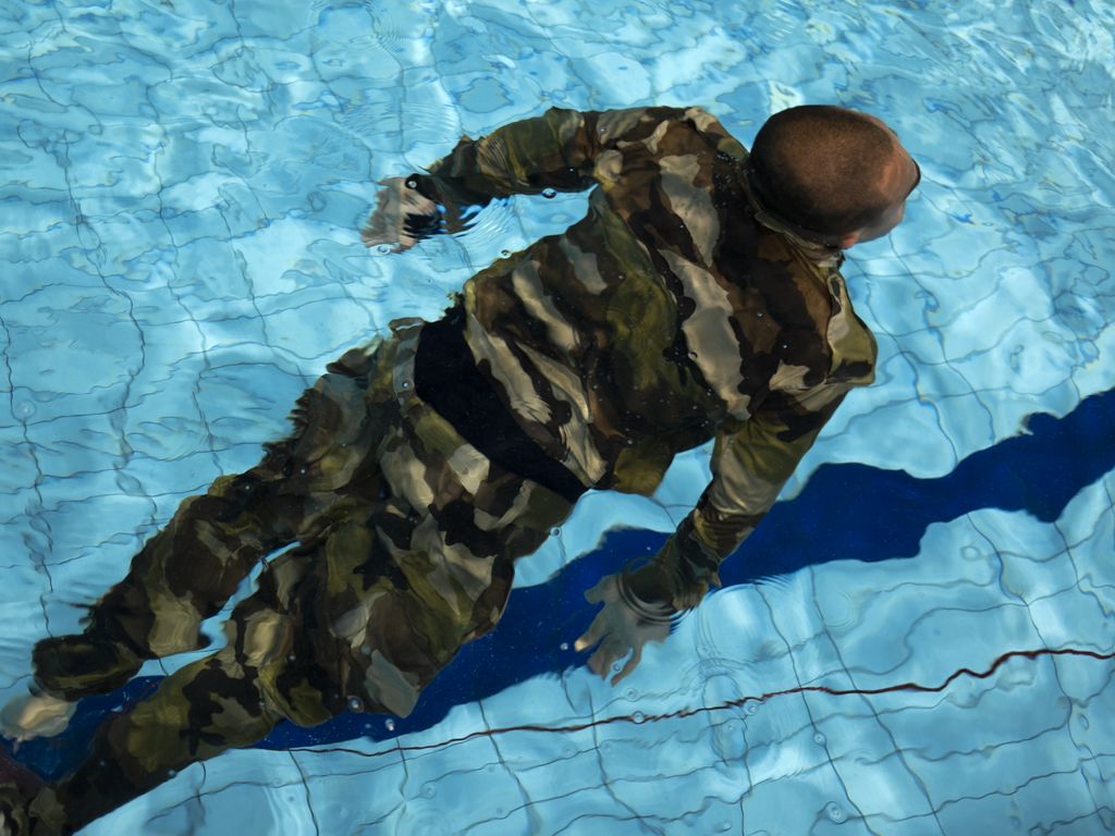 painting of man swimming