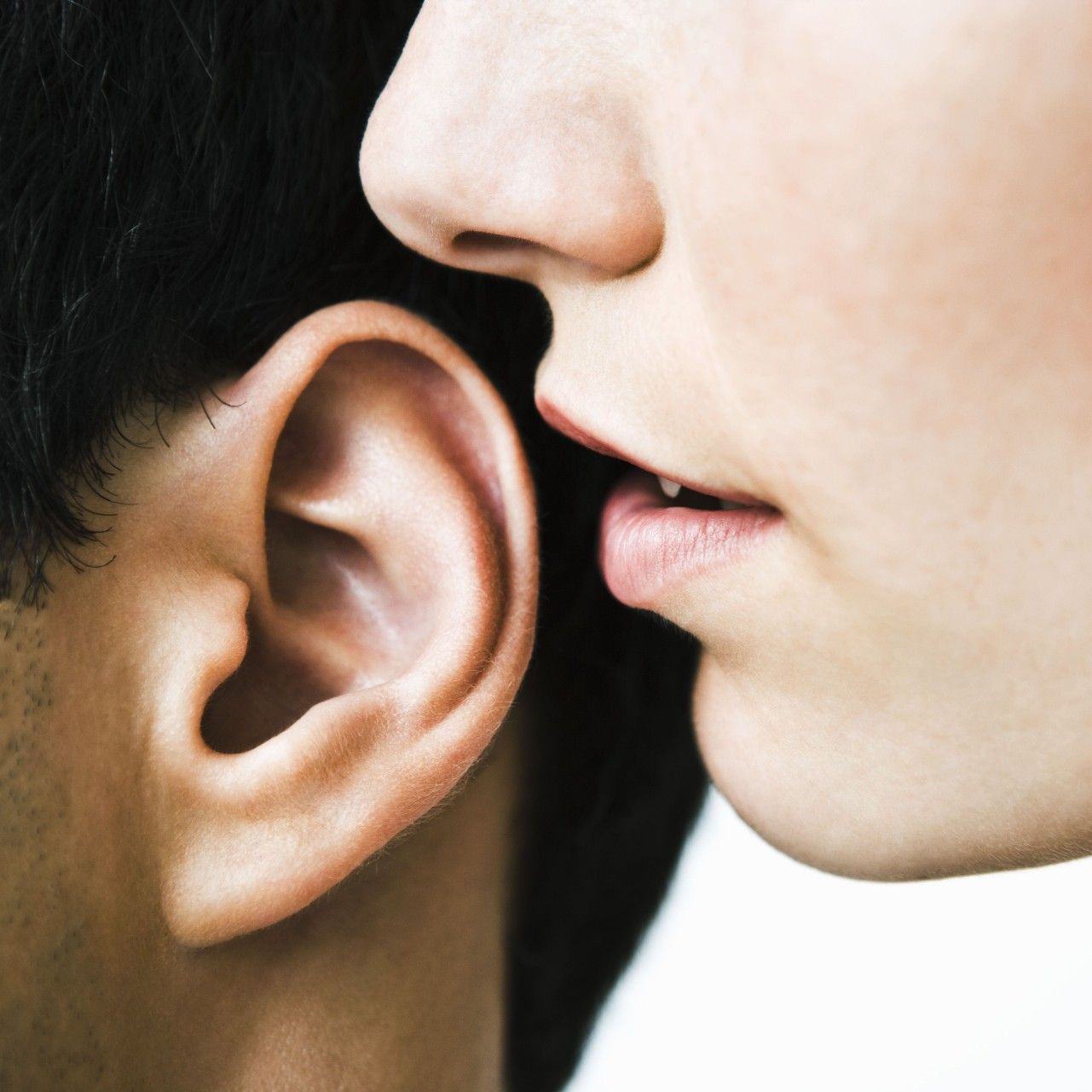 Woman whispering in a man's ear